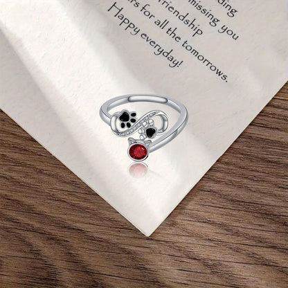 Bague ajustable avec empreinte de patte noire et pierre précieuse rouge