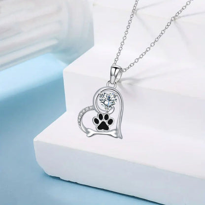 Collier artisanal avec empreinte de patte de chien et os en zircone